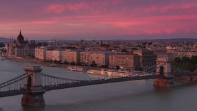 view of budapest from above at sunset pan from parliament to chain bridge