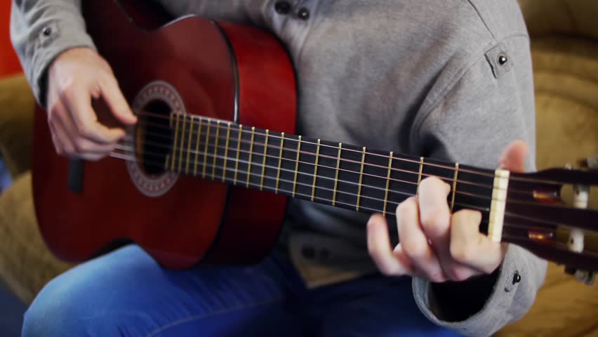 man playing an acoustic guitar