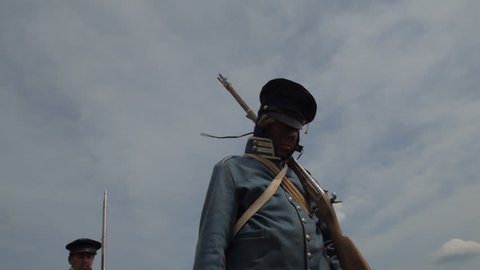VIRGINIA - AUGUST 2017 - Mexican War Soldiers - Re-enactors, reenactment.  American Army Soldiers with musket rifles march through dusty Mexican desert, trudging, tired and wounded.  Silhouette in Sun