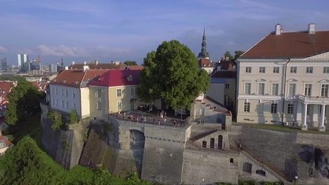 People on a viewing platform next to Estonian government building at Tallinn old town