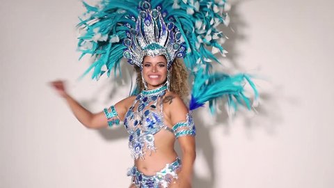 Beautiful and happy brazilian woman dancing samba while wearing traditional costume