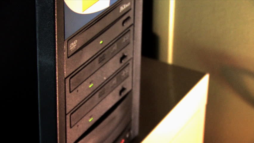 A CD/DVD duplicator ejects its contents.