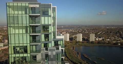 Aerial drone footage of apartment buildings in Woodberry Down, London, England on a bright sunny day.
