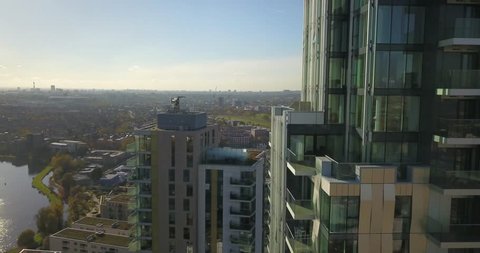 Aerial drone footage of apartment buildings in Woodberry Down, London, England on a bright sunny day.