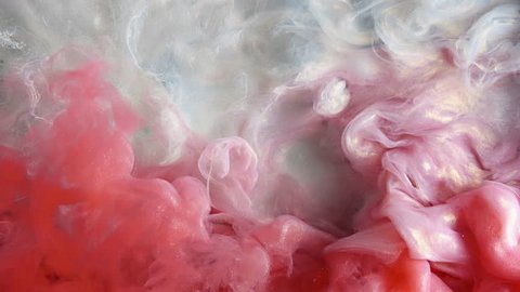 Colorful red/white paint drops from above mixing in water. Ink swirling underwater. Cloud of ink isolated. Colored abstract smoke explosion animation. Close up view