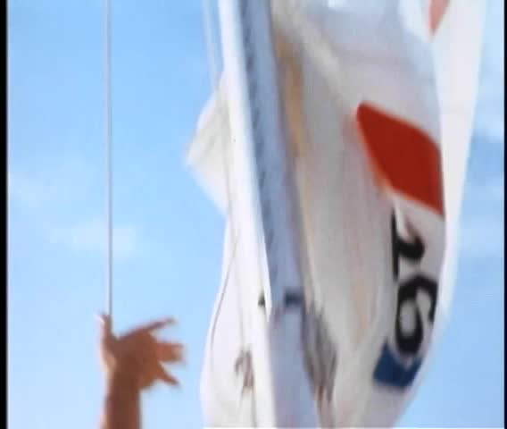 Low angle view of person hoisting sail