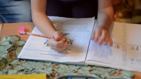 Girl is making her homework. Children learning at home. Children education