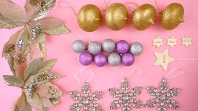 Colorful Christmas overhead in modern pink, gold and silver theme flat lay of ornaments, final real time. 