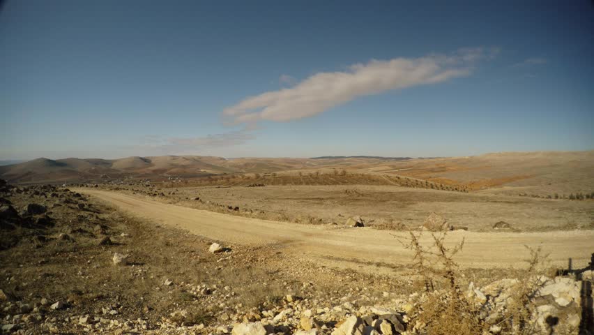 The dirt road goes to the hills in the distance to Gebekli tepe, the desert, the East of Turkey, the border with Syria | Shutterstock HD Video #32626432