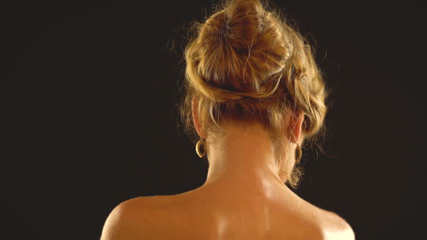 Woman neck and man hands helps girl to wear jewelery. Friend puts necklace on elegant lady. Romantic evening for loving couple on black background.