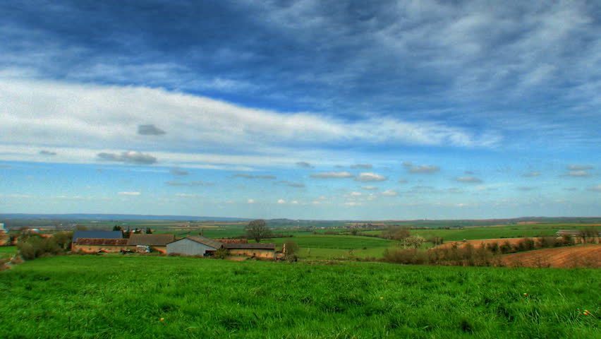 Clouds over farm fields, HD time lapse, high dynamic range imaging 