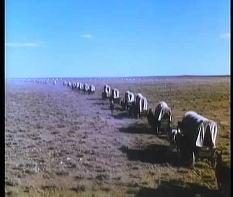Montage of covered wagons and settlers traveling cross country