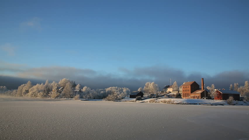 Distant village at the fjord in winter landscape