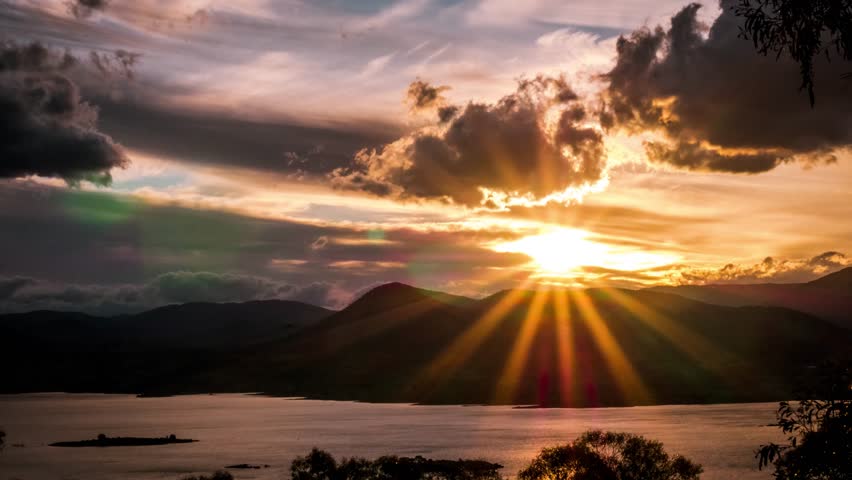Mountain Sunset by Lake. Island silhouette complimented by the Mountains. Cloud Layers time lapse color shift. Royalty-Free Stock Footage #32638015