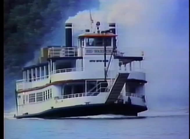 Steam boat traveling on river