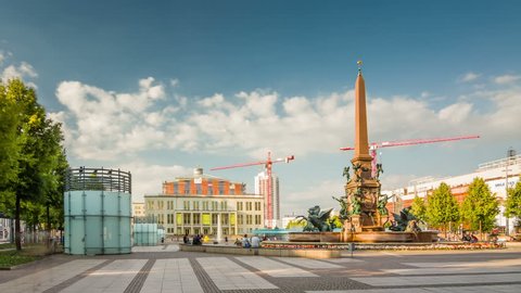 LEPZIG, GERMANY - AUG 26, 2017: View of Mende Fountain in foreground and of Leipzig Opera im Background at Augustusplatz, Leipzig, Germany. Timelapse view.
