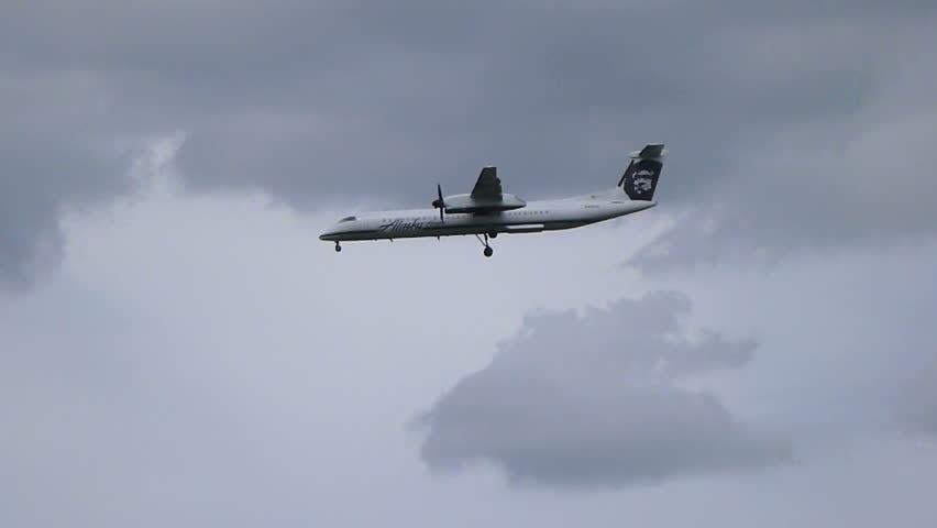 PORTLAND, OREGON - CIRCA 2012: Commercial passenger airplane flying overhead on