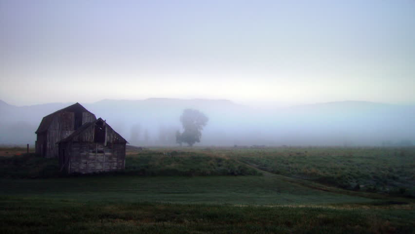 High definition time lapse of fog on a landscape with an old barn.