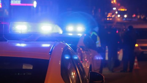 Three Police vehicle lights flashing on neighborhood