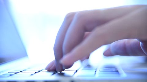 Female hands typing on a computer keyboard.