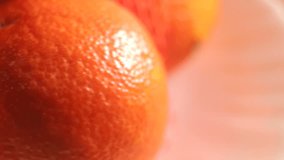 Texture of a cut mandarin orange close-up. Packing grid in the frame. Smooth motion. The focal length changes.