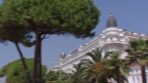 CANNES, FRANCE: Carlton hotel at boulevard + palm trees