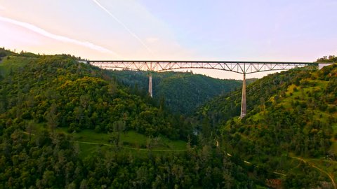 Cinematic aerial of The Foresthill, Auburn-Foresthill or Auburn road bridge crossing over the North Fork American River in Placer County and the Sierra Nevada foothills, in eastern California.