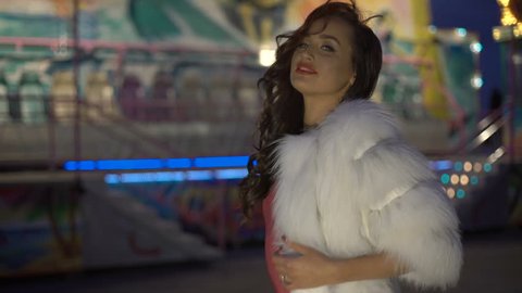Sexy rich girl's wearing furry coat at night street 4K.