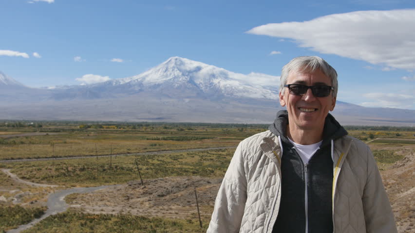 Caucasian handsome confident calm adult man with loving kind brown eyes athlete sportsman traveler in white jacket