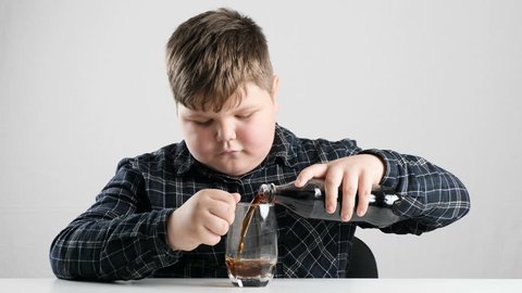 Young fat boy pours soda into a glass 50 fps 4k