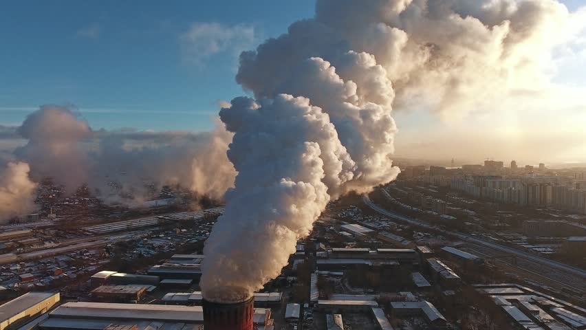 Industrial zone with a large red and white pipe thick white smoke is poured from the factory pipe in contrast to the sun. Pollution of the environment: a pipe with smoke. Aerial view Royalty-Free Stock Footage #32679241