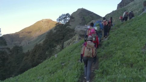 Group of hikers walking towards mountain summit in the early morning, Himalayas, India