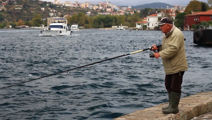 ISTANBUL - OCT 20: Senior fisherman passes hours along Bosporus Strait on