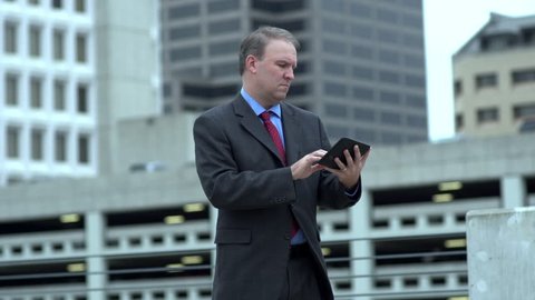 Businessman works on tablet