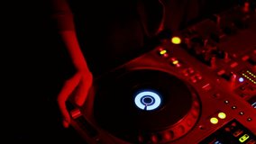 lifestyle, technologies, emotions, people, video, movie, 4K concept - Girl DJ dancing develop her hair behind multicolored lights. Silhouette DJ equipment, hands, face close-up. red highlights