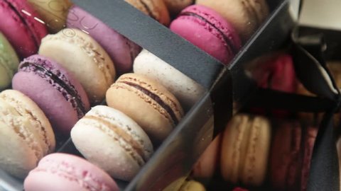 pan over colorful macaroons in a box