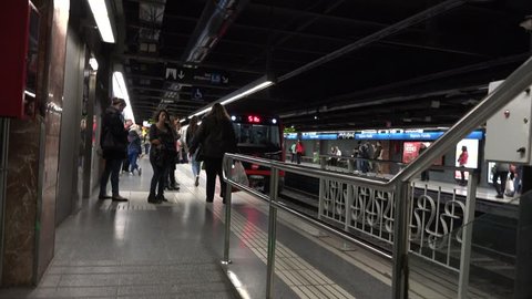 BARCELONA - SPAIN, APRIL 6, 2015,  Tilt up of subway metro train arrive in station, people get off