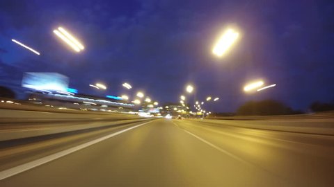 Night road POV through the city at night timelapse blue hour