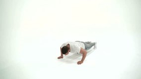 Fitness athlete man doing push ups in studio on a white background 4K