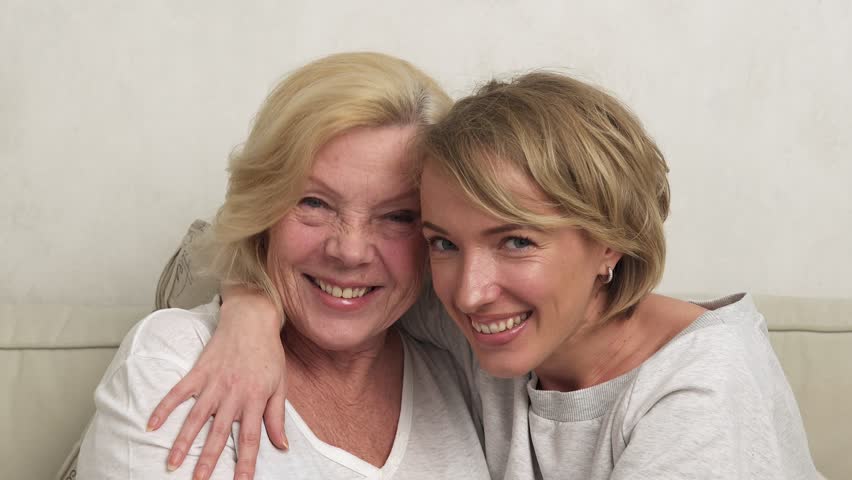 Happy adult daughter and elderly mother talking, hugging and laughing | Shutterstock HD Video #32706001
