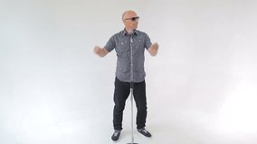 man sings a song charismatically dancing jumping with the microphone