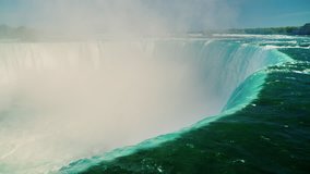 Rapid water flow of the Horseshoe waterfall on the Niagara River. The Niagara Falls, a popular place among tourists. 4k 10 bit video