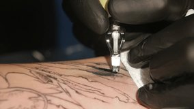 Tattoo artist make tattoo in studio, tattooing on the body. close up. s