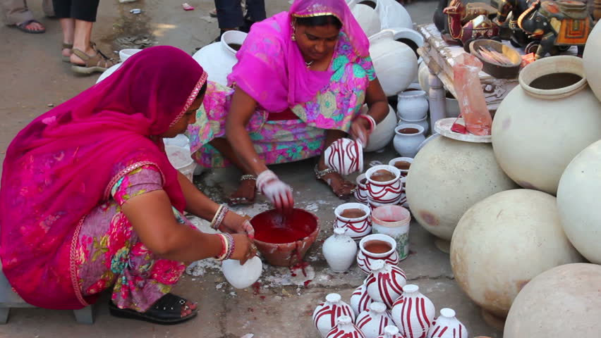 JODHPUR, INDIA - NOVEMBER 28, 2012: Women paint pots in the city market in