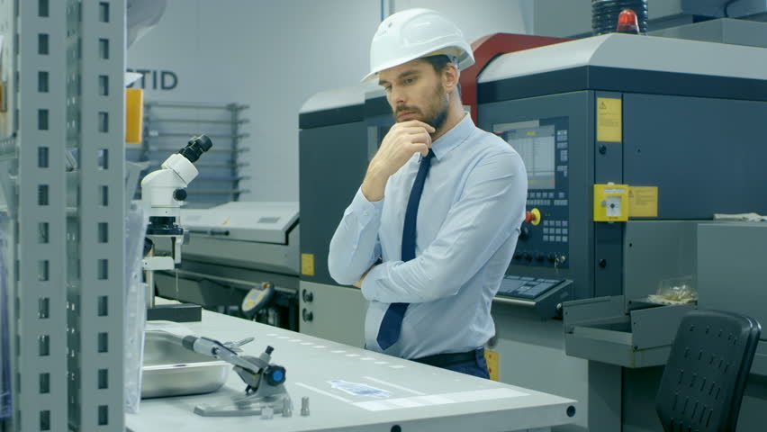 In High Tech Futuristic Factory Chief Engineer Works with Holographic Projection 3D Model of the Engine Turbine Prototype. Futuristic Desing of Virtual Mixed Reality Application.