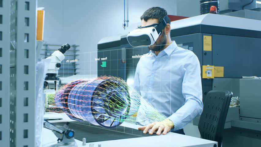 Factory Chief Engineer Wearing VR Headset Designs Engine Turbine on the Holographic Projection Table. Futuristic Design of Virtual Mixed Reality Application. Shot on RED EPIC-W 8K Helium Cinema Camera