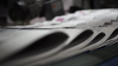 Print the newspaper from a short distance. The process of offset and roll printing. Production of the newspaper. Paper passing from the press.