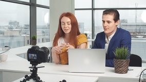 Two bloggers are recording video on camera.