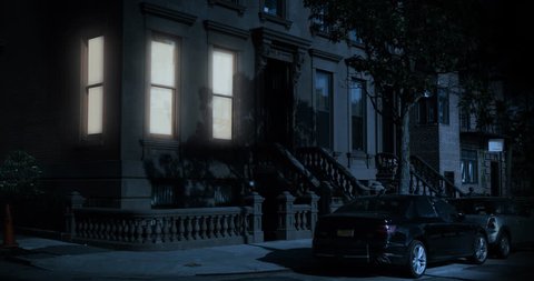 A nighttime exterior establishing shot of the first floor of a typical Brooklyn brownstone residential home as a room's windows lights up then turns off.	Day/Night matching available.
