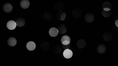 Circular white lights on black background - white bokeh